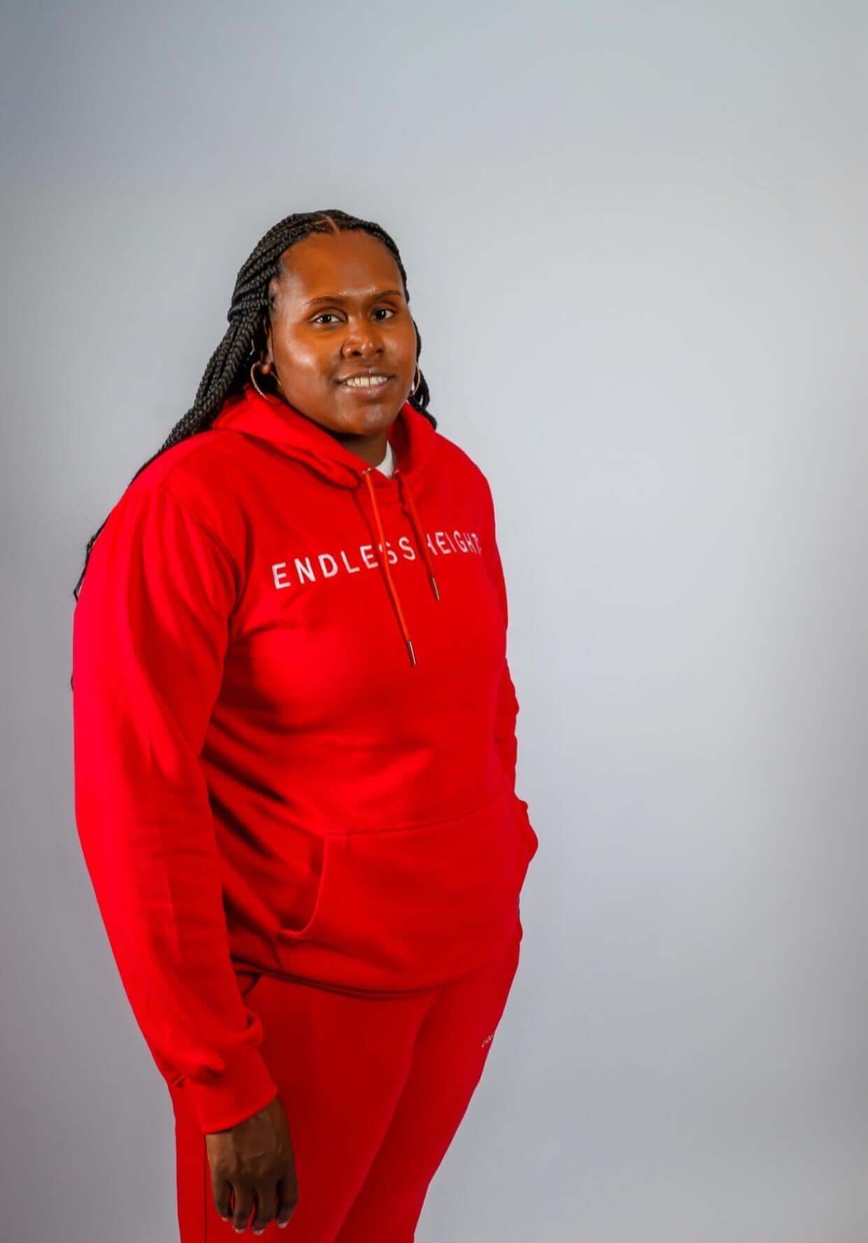Sky High Stacked Jogging Sets worn by a person in a bright red tracksuit with ENDLESS HEIGHTS text.
