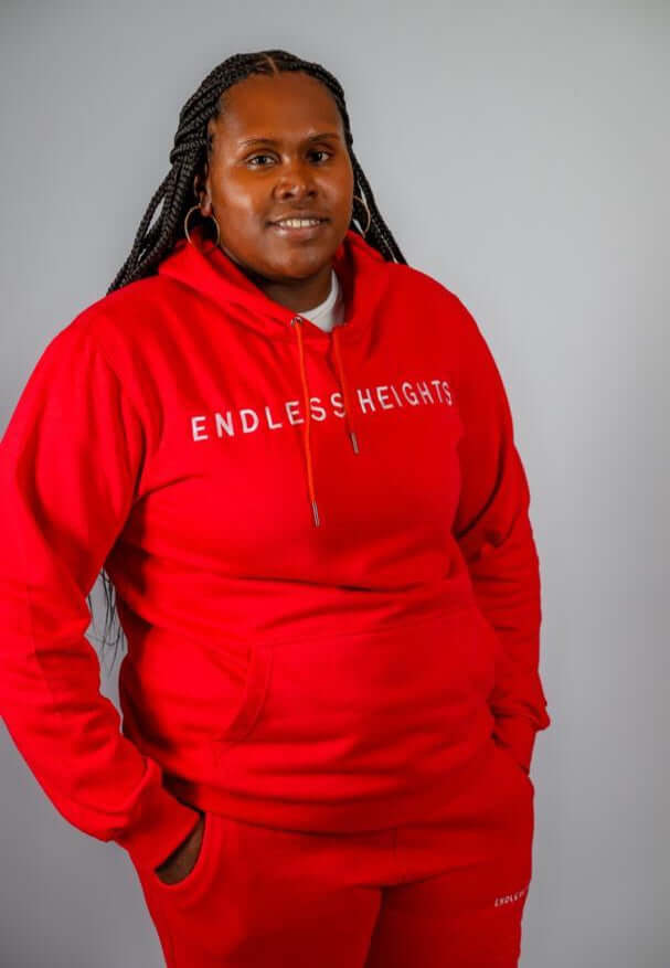 Model showcasing Sky High Stacked Jogging Sets in red, featuring the ENDLESS HEIGHTS brand logo, perfect for casual style.