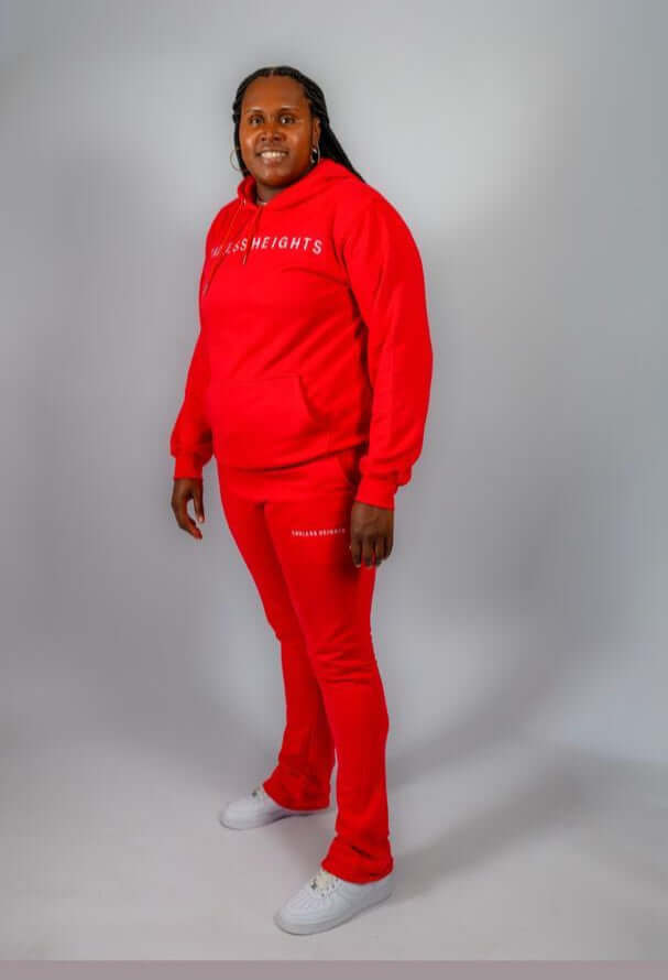 Model wearing red Sky High Stacked Jogging Sets featuring a hoodie and pants for casual style.