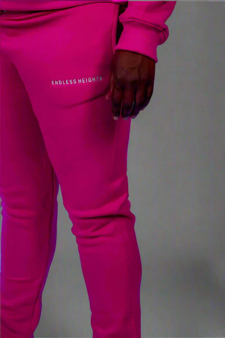 Taller Than LIfe Collection ENDLESS HEIGHTS tracksuit set in vibrant pink featuring matching hoodie and pants.