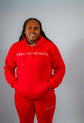 Model wearing red Sky High Stacked jogging set from ENDLESS HEIGHTS, showcasing casual athletic style.